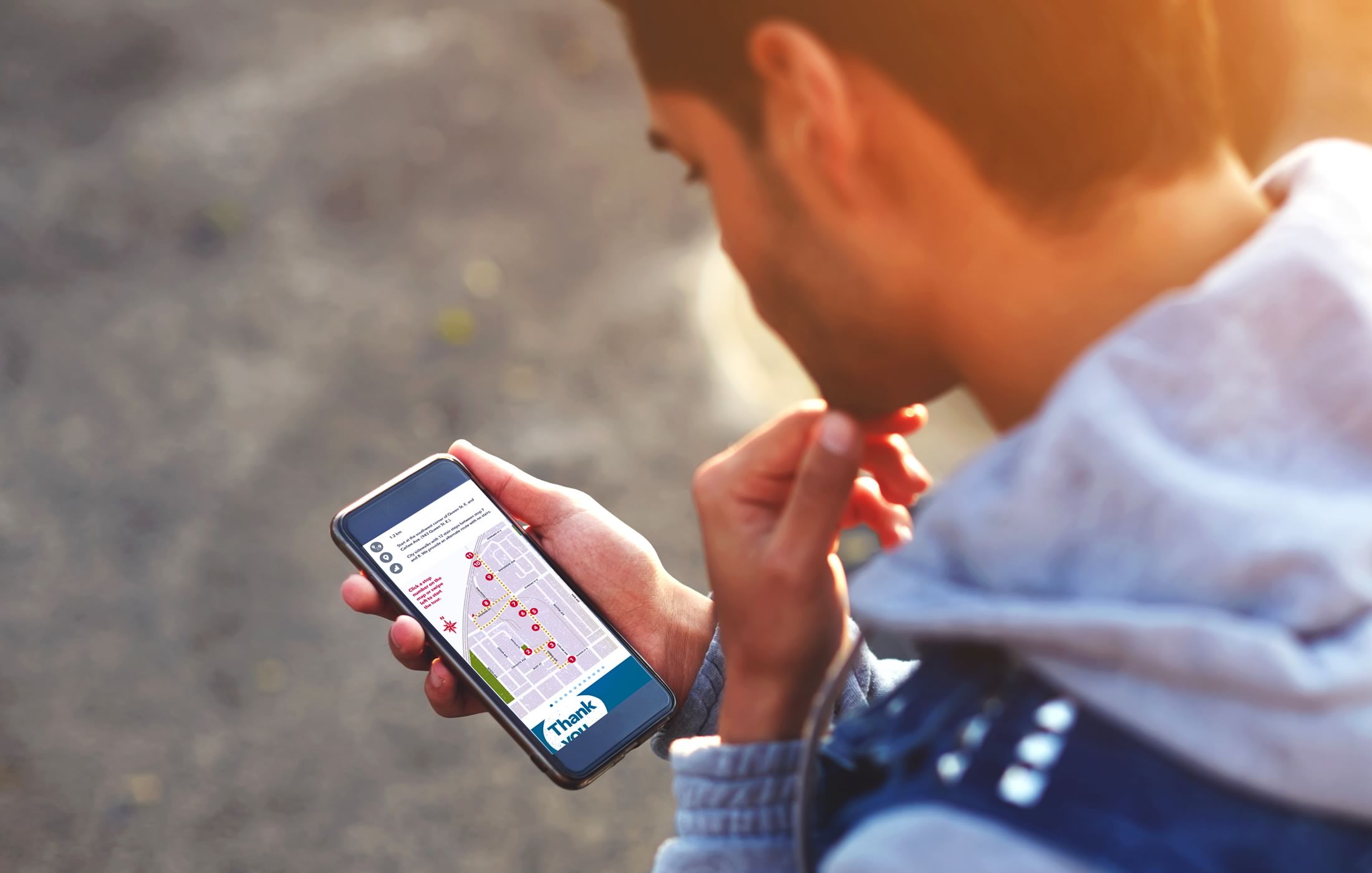 Closeup of a person interacting with the Made in Toronto tour/website on their mobile phone