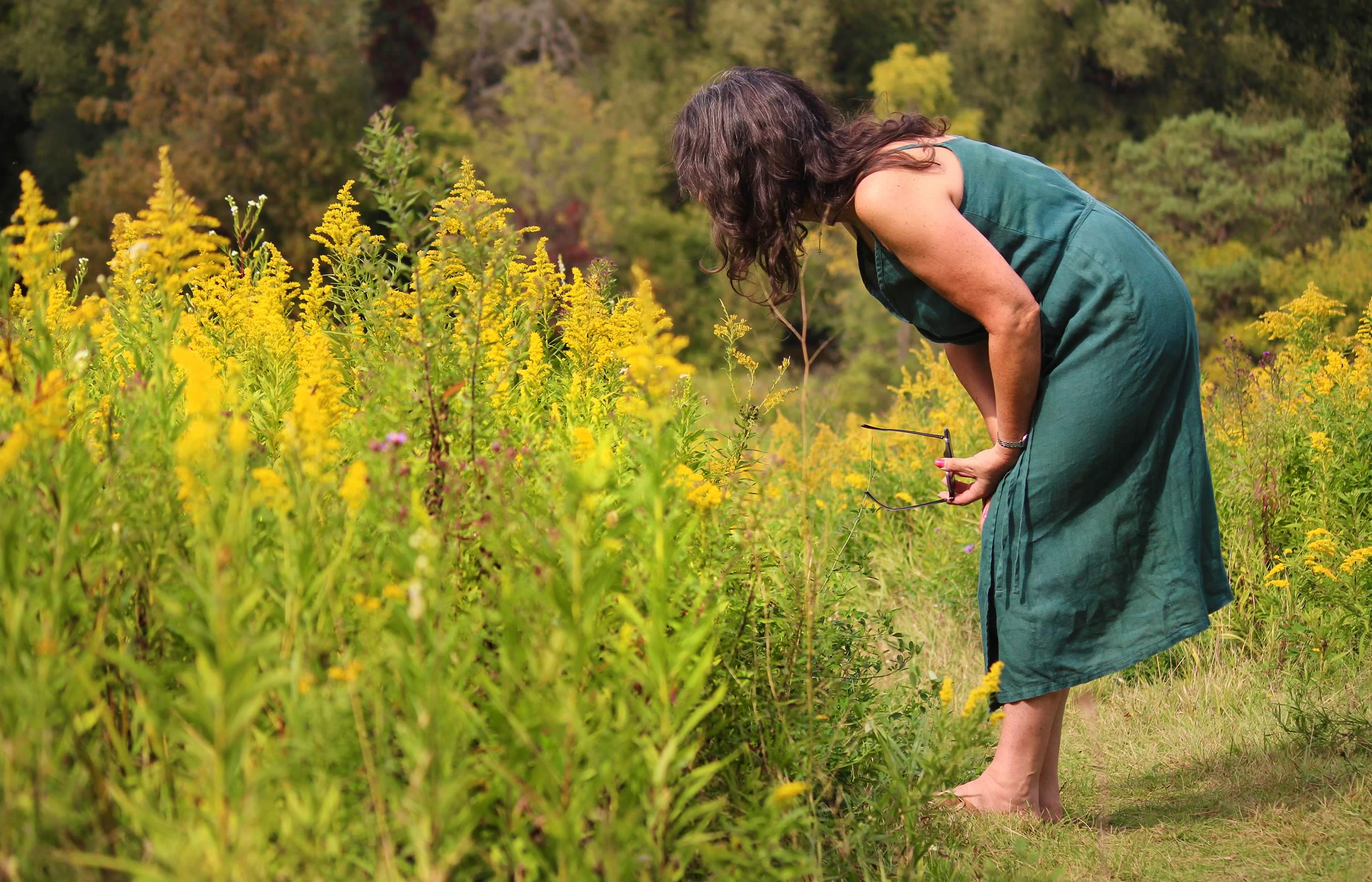 Photograph of Maxine Wright modeling a linen dress that she designed